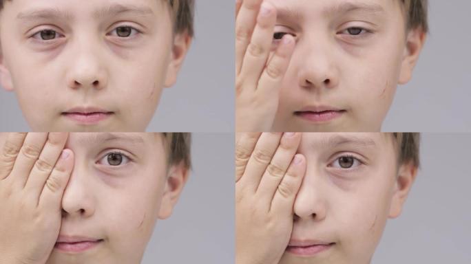 9岁的高加索男孩用手掌闭上眼睛。