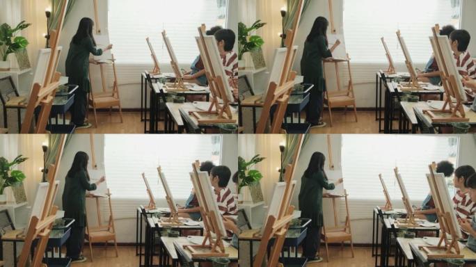 A female Asian teacher teaches kids about acrylic 