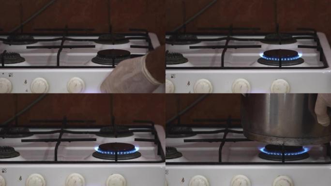 库克将旧锅放在厨房生锈的煤气炉上