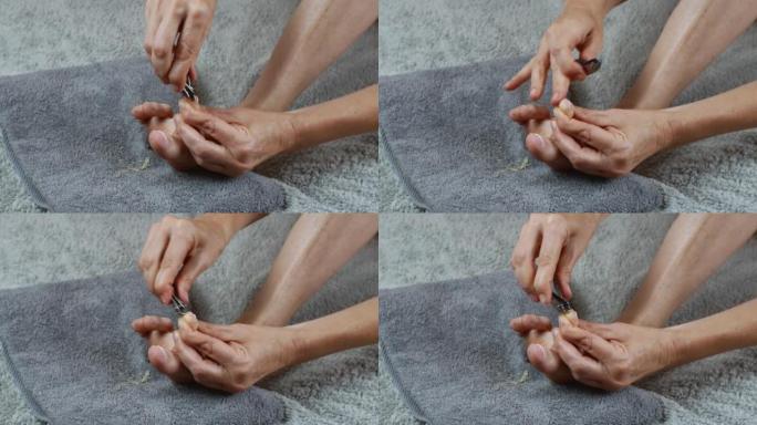 脚趾指甲护理过程的特写。一个女人通过割脚趾甲来照顾她的脚。保健、女性身体卫生的概念