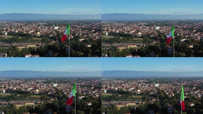 在阳光明媚的秋日里，意大利北部威尼托维琴察市中心的美丽无人机景观，城市天际线和意大利国旗上有主要建筑