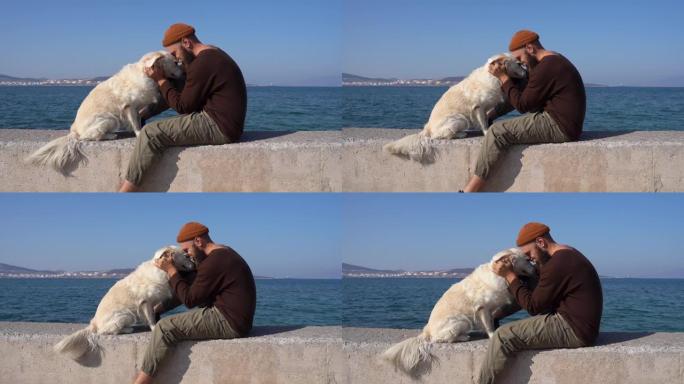 男人拥抱他的宠物狗金毛猎犬。狗主人在长时间分居后想念他的动物朋友。孤独和友谊。健康，生活方式活动。