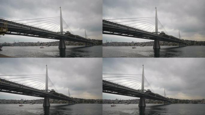 多云的一天伊斯坦布尔市著名的海湾地铁大桥慢动作全景4k土耳其