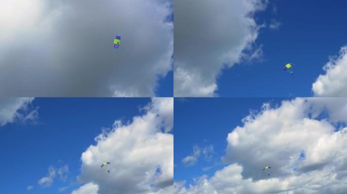 一个人从极限运动中肾上腺素上瘾，跳伞者在蓝天上放飞带着翅膀形状的降落伞云。为寻求刺激的人准备的极限运