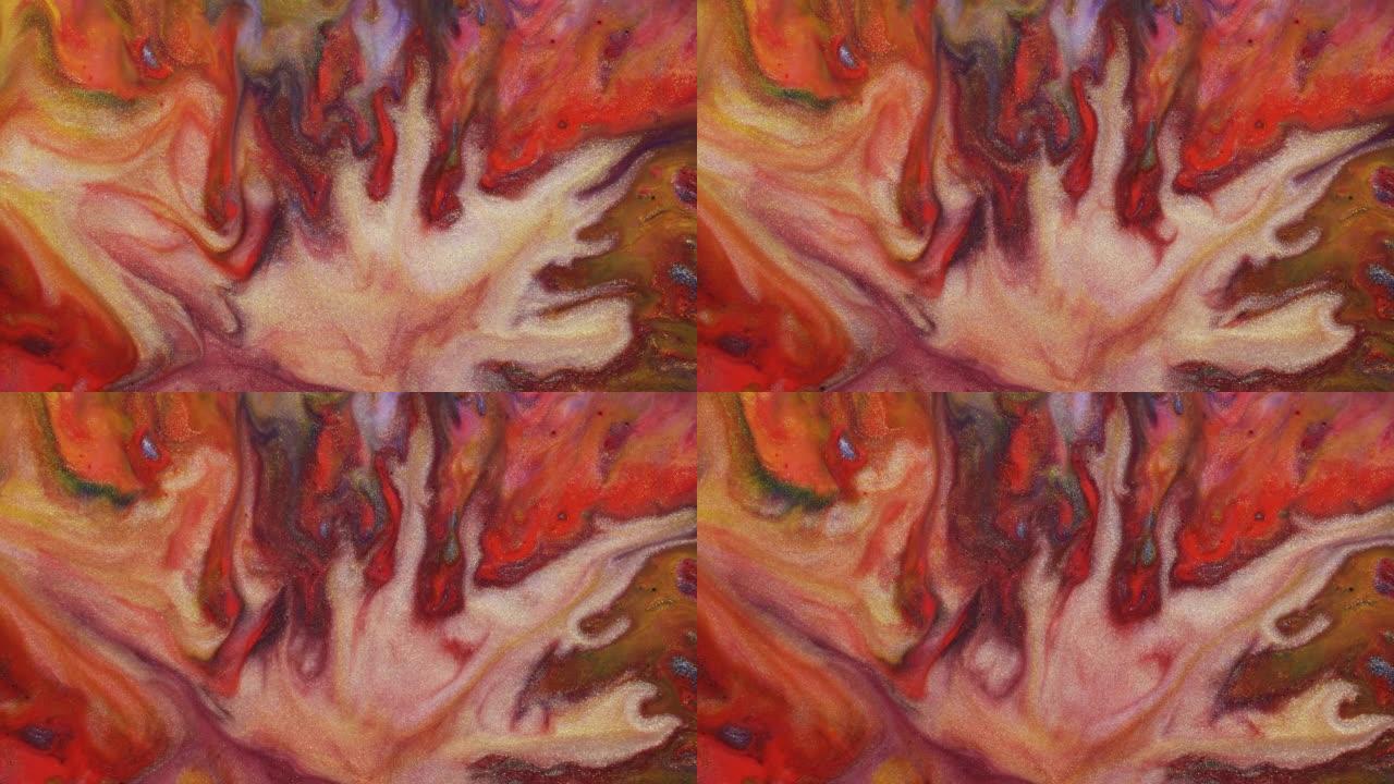 五颜六色的红色和橙色油漆散布在宇宙色彩表面混合在梦幻般的设计和图案中。金粉闪闪发光的颗粒，墨滴和混合