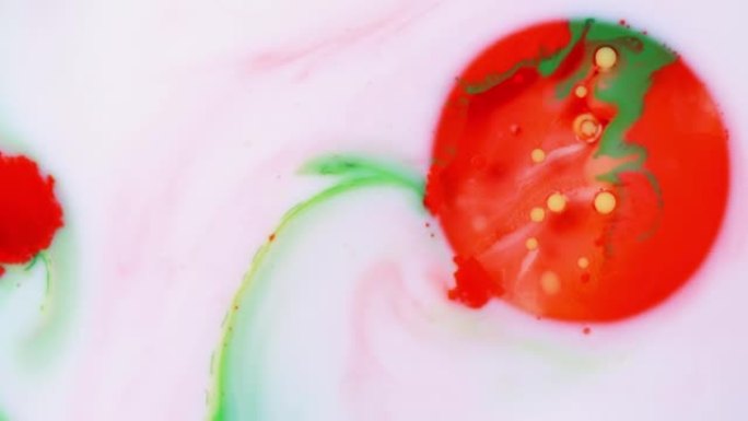 彩色丙烯酸涂料气泡散布在白色表面上，并混合在抽象的纹理和设计中。红色、绿色和黄色油墨球滴和混合。奇妙