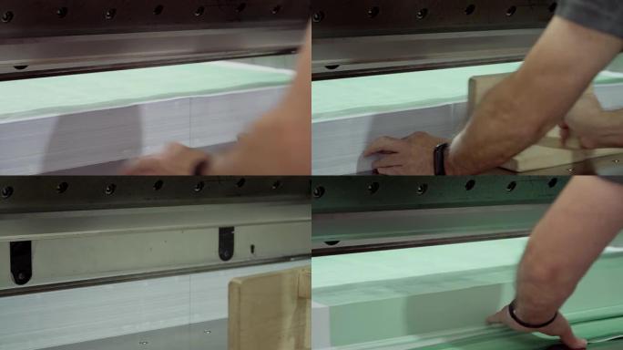 工人在a中使用切纸机切割纸张
印刷厂