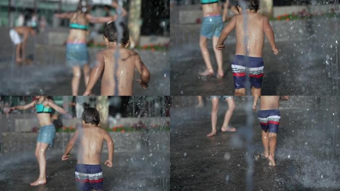 在城市的夏日里，兴奋的孩子在喷泉的公园喷水中玩耍。孩子在慢动作中玩得开心