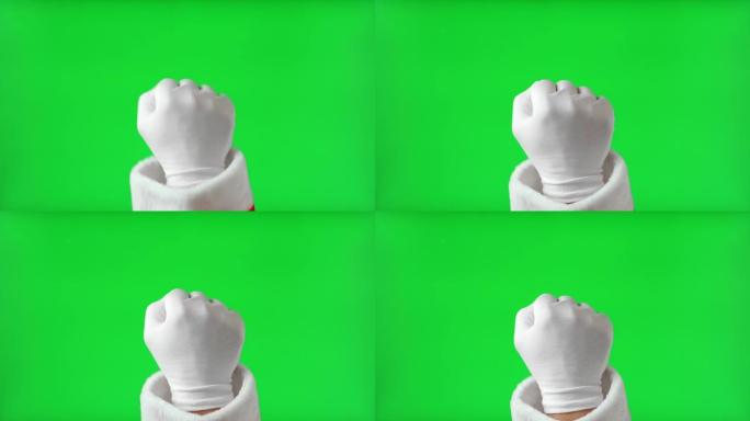 手势包。圣诞老人手握白手套敲孤立的色度键绿色屏幕背景。4k镜头。圣诞老人的拳头打手势敲门。假期就要到