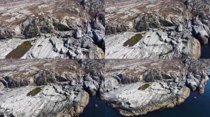 挪威海岸线海浪和岩石的鸟瞰图，telav å g。海边岩石的全景。海浪沿着海岸滚动。从空中俯瞰海岸。