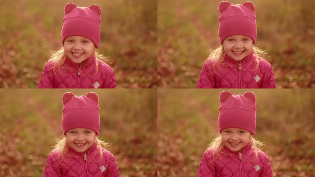 滑稽小女孩笑的肖像，特写。秋季公园可爱的孩子