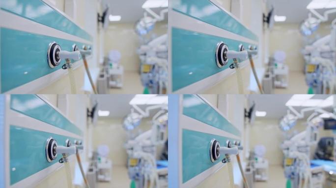 管子连接到手术室墙上的面板上。现代医院设备多样的空手术室。模糊的背景。