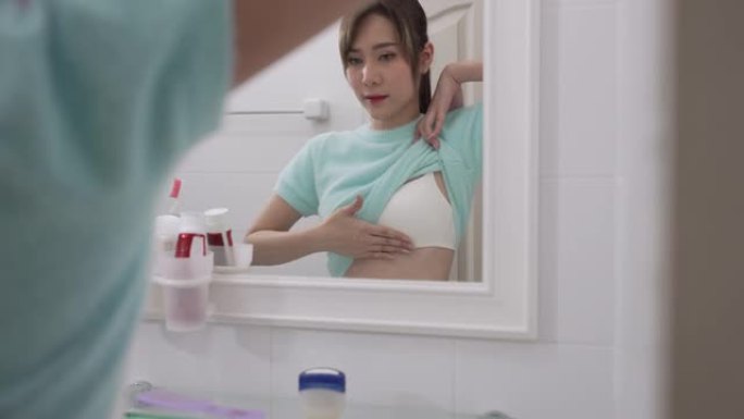 乳腺癌，世界癌症日。美丽的年轻女子检查乳房肿块或癌症。