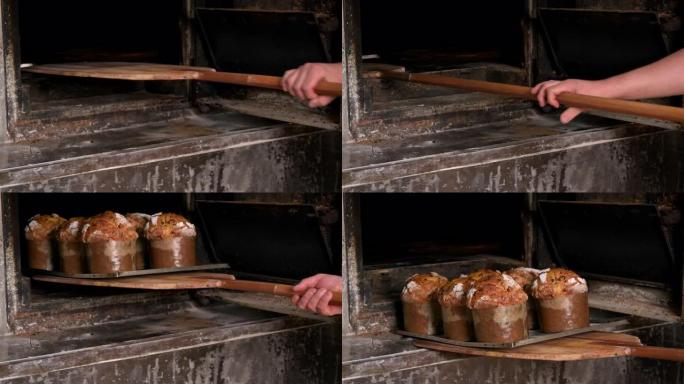 面包师从烤箱里取出烤面包盘。高质量4k镜头