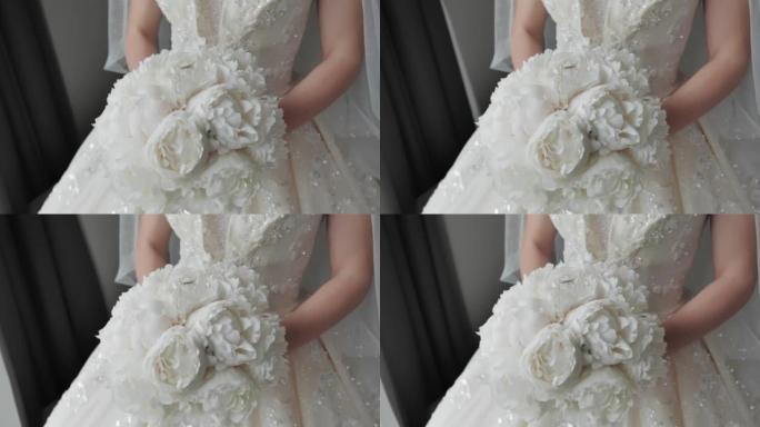 新娘穿着奢华的婚纱，带着一束鲜花