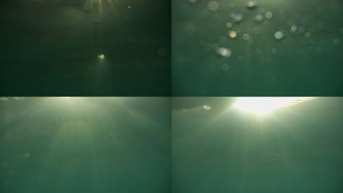 溺水。水面下散焦的气泡。靠近水面和水深的气泡。水面下耀眼的阳光。水4