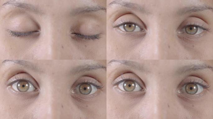女人，眼睛和视觉觉醒的意识的眼睑眨眼的视觉和聚焦细节的淡褐色的瞳孔和虹膜。女性在聚焦视力中睁开眼睛的