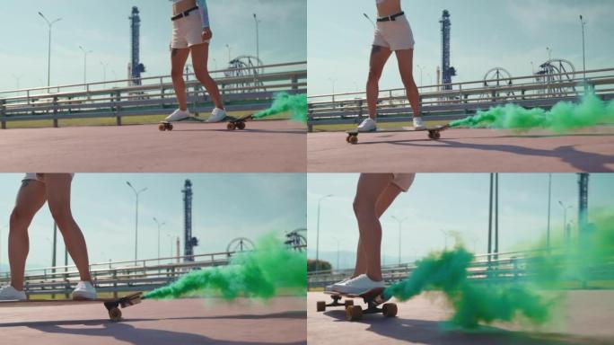 腿上有纹身的女人骑着长板，穿着时髦的彩色烟雾弹，积极的运动和能量
