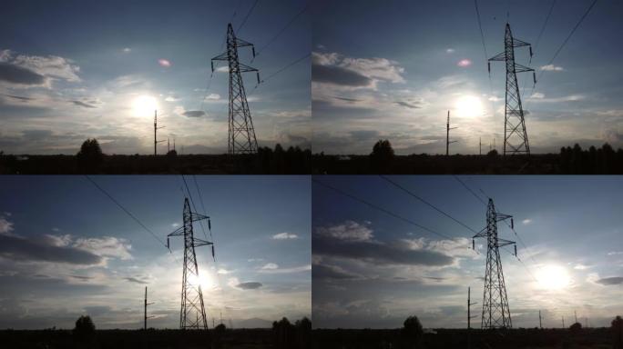 乡下日落时天空中电线杆和电线的无人机镜头。黄昏时电线杆的轮廓。