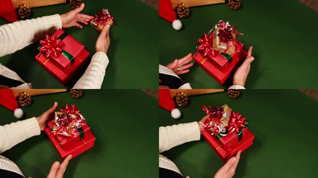顶视图女人堆叠圣诞礼品盒，一对一，在绿色背景上盘旋，并带有复制广告空间。