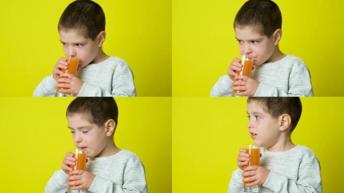 美丽的5岁男孩喝橙汁，舔黄色背景