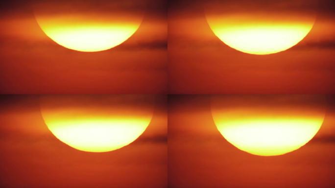 通过长焦镜头拍摄的大红橙色日落。