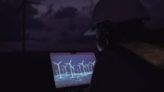亚洲女性工程师在夜间使用虚拟触摸屏在风力涡轮机发电站中使用全息技术控制风力涡轮机能量。