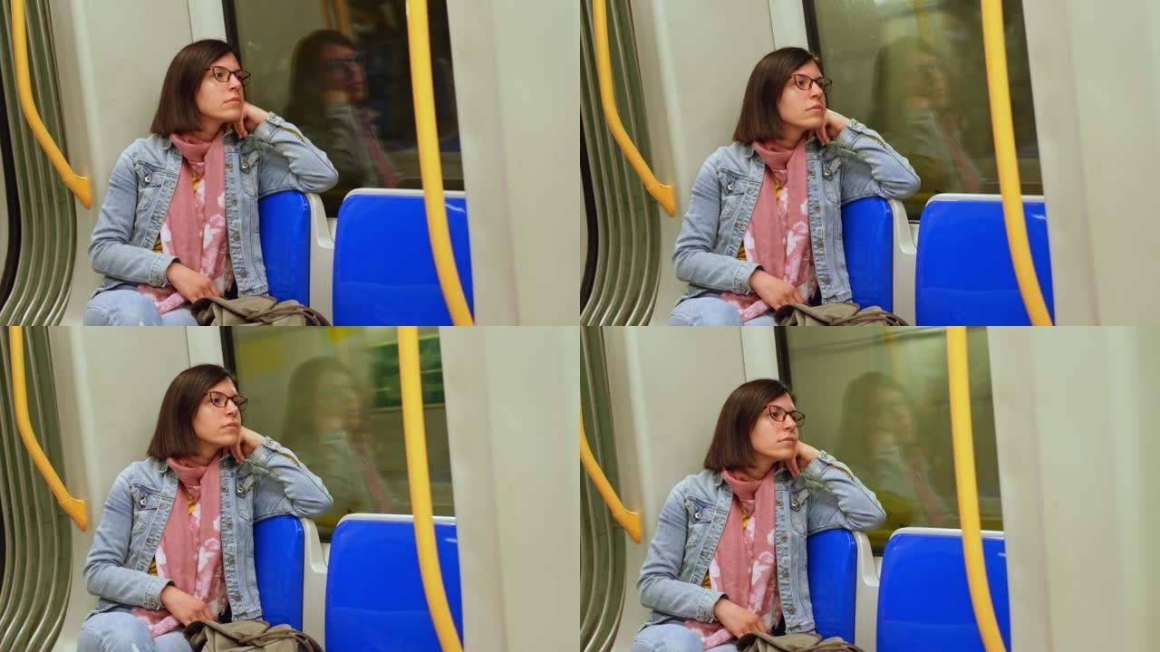 沉思的女人看着地铁窗外