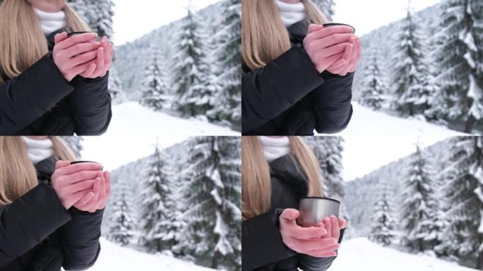 美丽的年轻女子在户外的冬季森林中散步，她拿着一个装有茶，热饮的热水瓶。