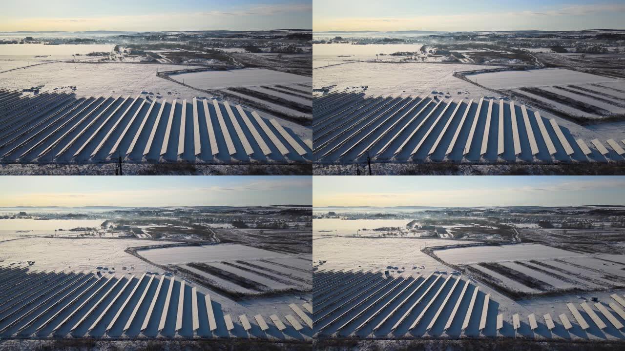 白雪覆盖的可持续发电厂的鸟瞰图，带有许多排的太阳能光伏板，用于产生清洁的电能。冬季可再生电力的低效性
