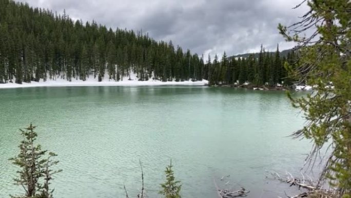 俄勒冈州喀斯喀特湖被雪和常绿树木包围的魔鬼湖