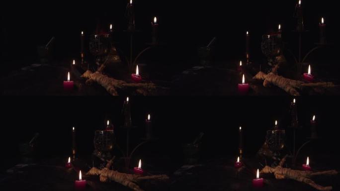 静物撒旦，带有热气腾腾的牺牲杯和黑色背景的蜡烛。