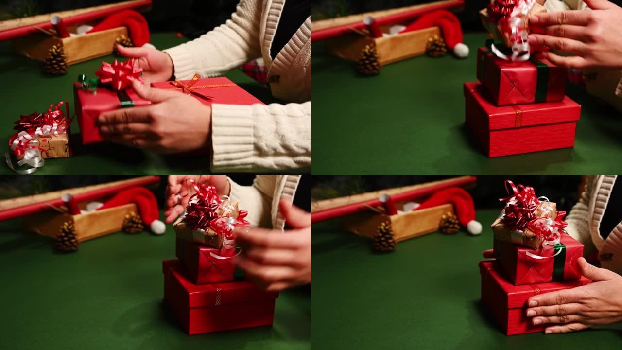 一个女人一对一堆叠礼品盒的特写镜头，用于圣诞节，新年或任何其他庆祝活动。节礼日