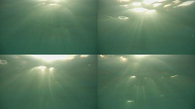 溺水。水下阳光。不同形式和形状的气泡在水中。版本2