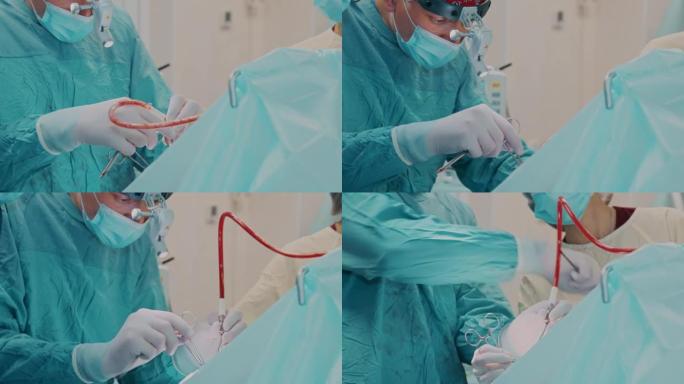 外科医生操作口腔区域，用烧灼笔烧灼伤口内部，并使用手术剪刀和镊子进行手术