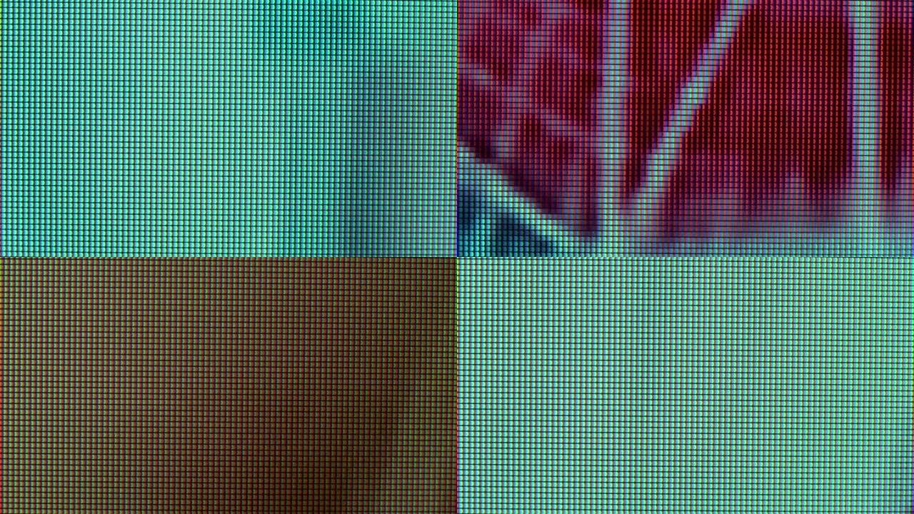 电视节目播放时的电视LED屏幕的宏观视图。近距离观看时，彩色像素会创建抽象图案。