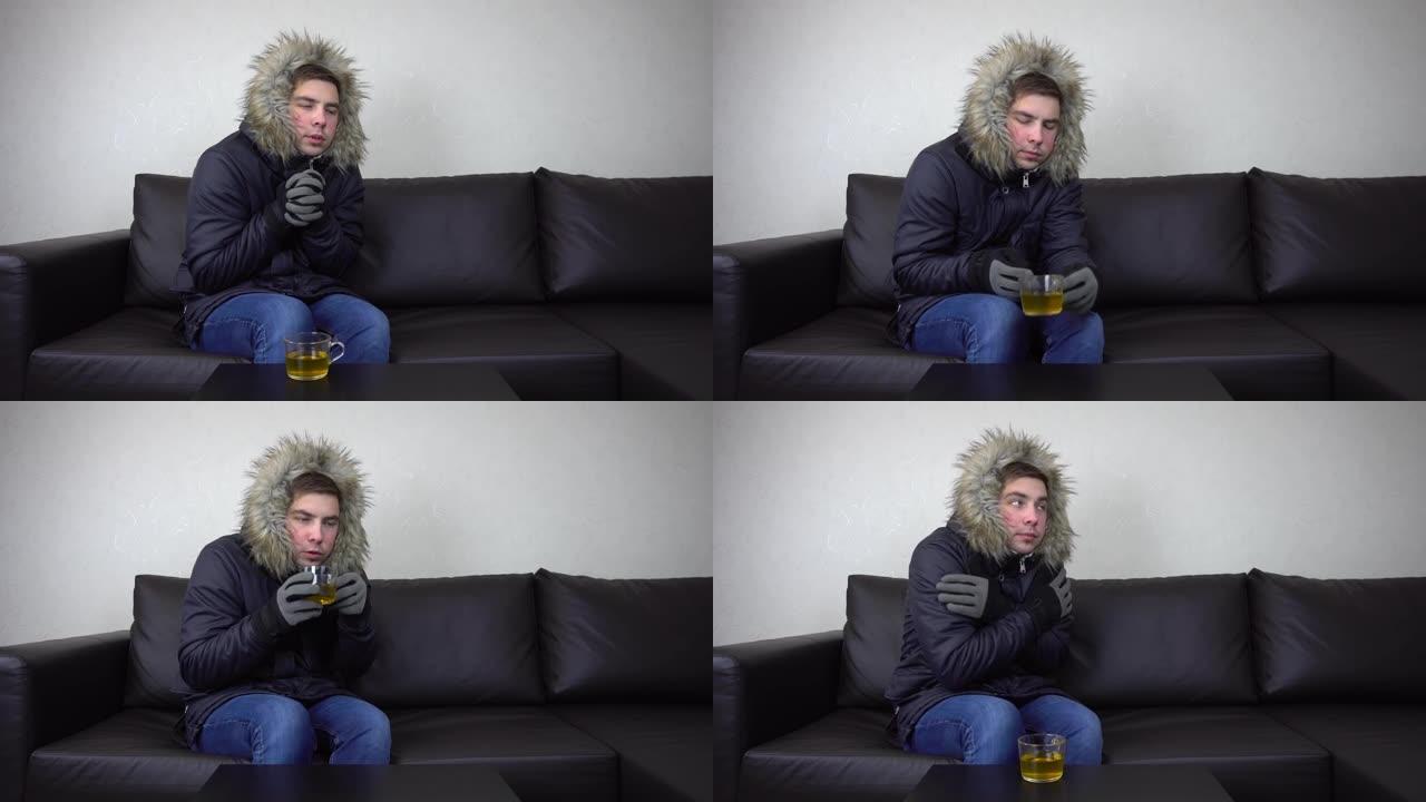 一个年轻人穿着冬衣坐在家里，试图保暖。一个人因为逃税而坐在没有暖气的沙发上。4 k