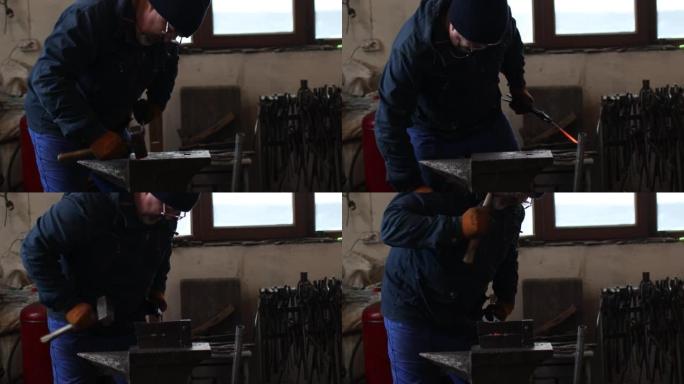 铁匠用铁锤和铁砧锻造并制作箭头箭头金属细节。