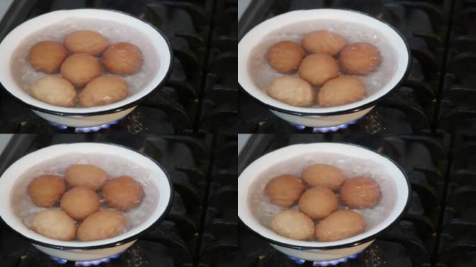 鸡蛋在金属碗中煮沸。