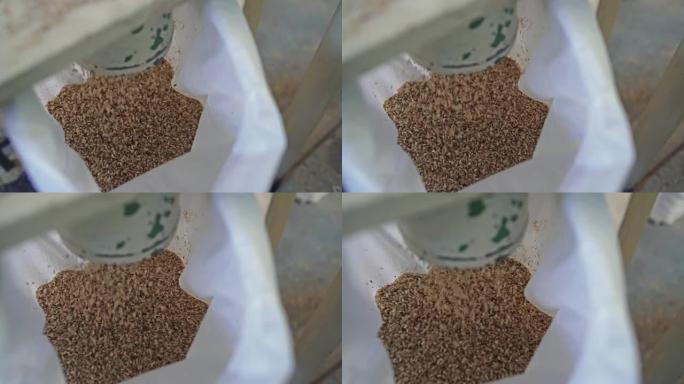 有机糙米慢动作倒入包装袋中。碾米厂生产厂