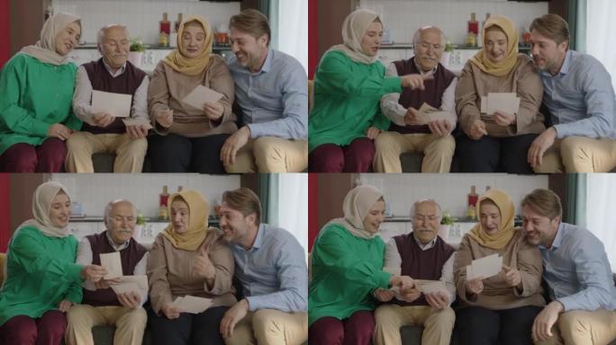 幸福的穆斯林大家庭通过看老照片来回忆他们的记忆。