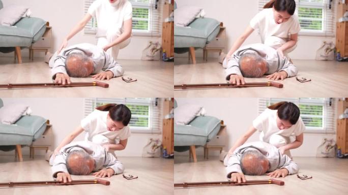 亚洲女性女儿或孙女帮助老年男性在家中客厅摔倒。年老的老爷爷在接受物理治疗后心脏病发作