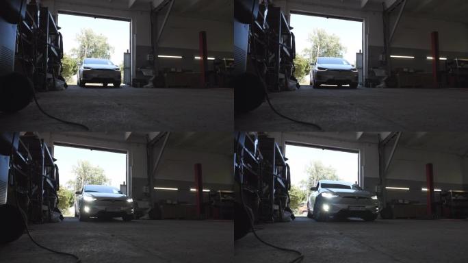 现代电动汽车驶入车库进行维修的特写镜头。电动SUV汽车驶入车间。运输服务的概念。慢动作
