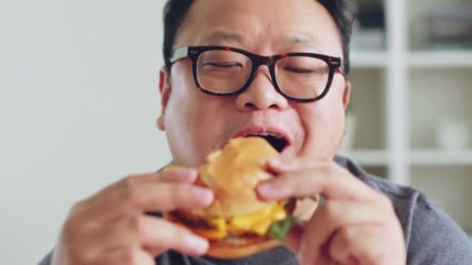 亚洲胖子喜欢吃不健康的垃圾食品，汉堡包，比萨饼，炸鸡