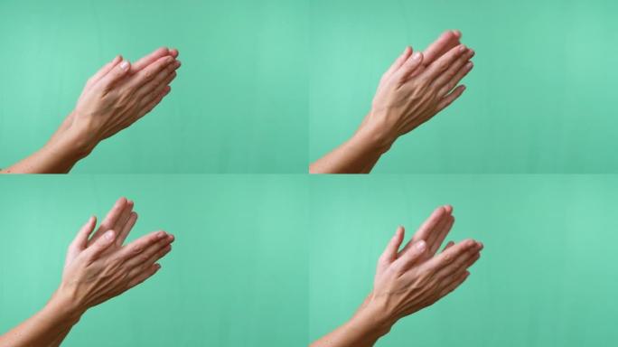 女性双手在空的孤立绿色色度关键背景上拍手