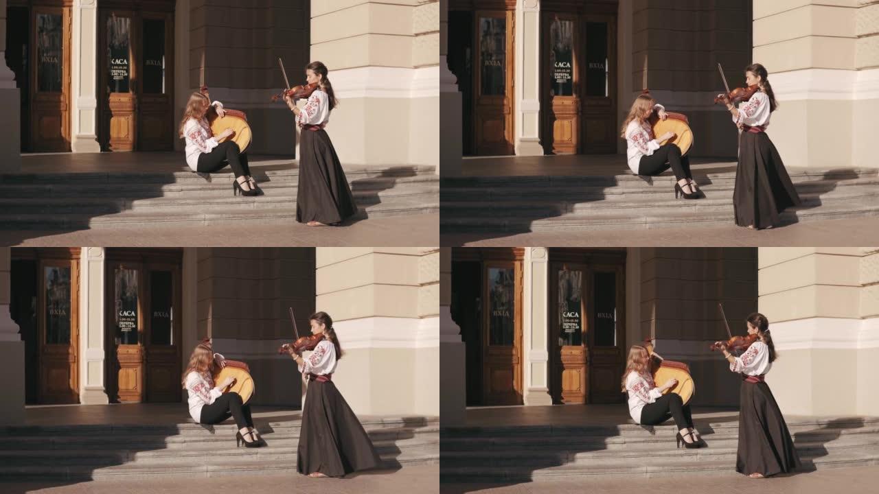 两位穿着刺绣衬衫的音乐家女性在日落时演奏古典乐器、小提琴和班杜拉