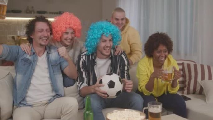 朋友在家里庆祝足球队获胜