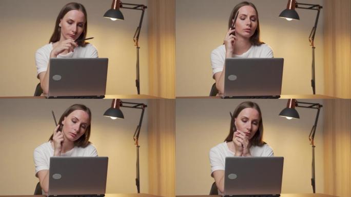 女性高管正在考虑使用笔记本电脑的员工工作时间表