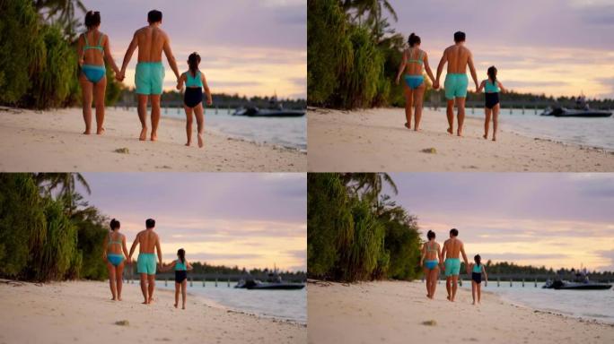 日落时分在海滩上一家人在一起