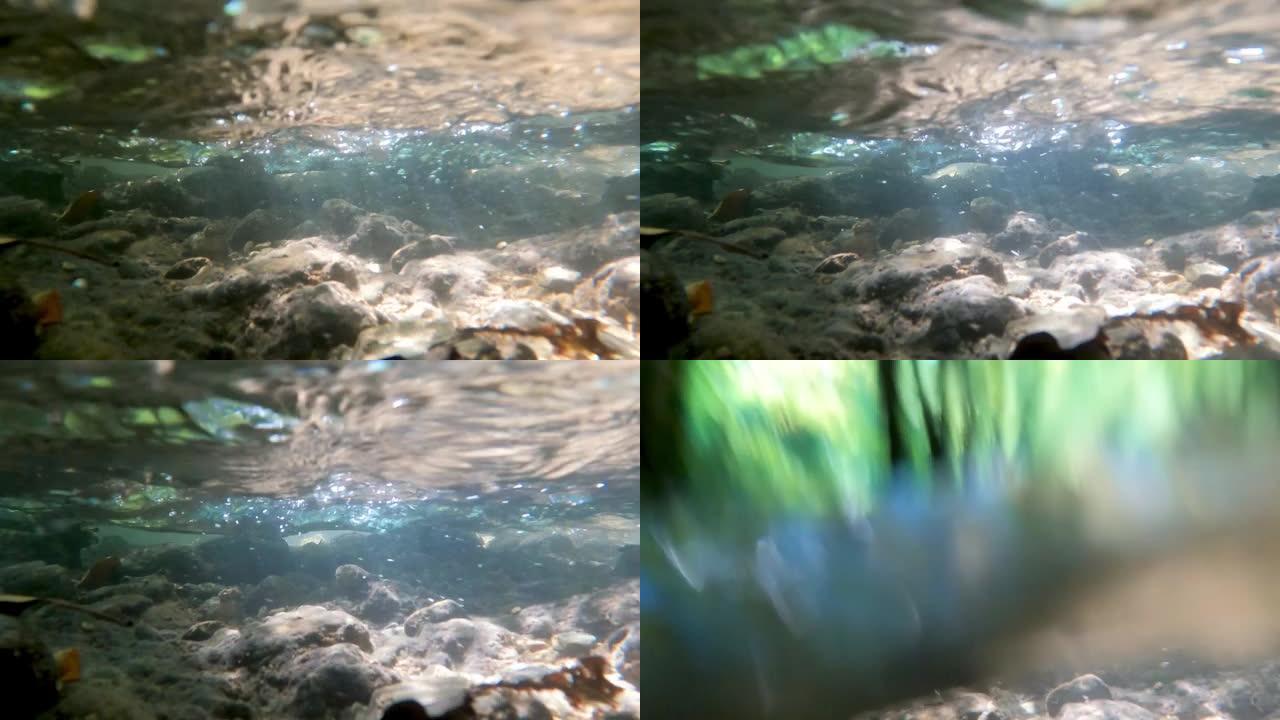 美丽的水下画面，河流在覆盖底部的岩石上方流动